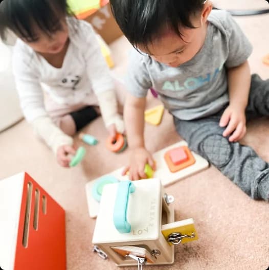 Two children playing with toys from Lovevery