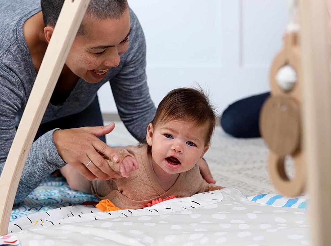 Baby doing tummy time on The Play Gym by Lovevery