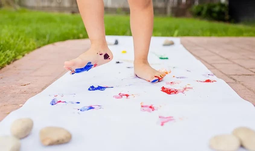 Child walking with painted feet